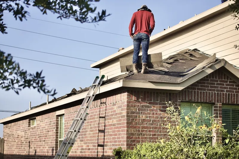 Professional roofer working on a residential roof in Almadale Farms